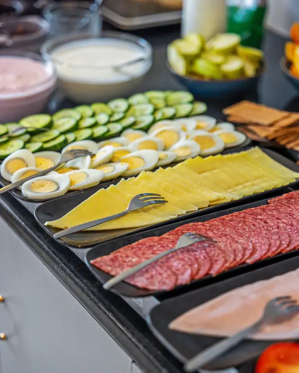 Breakfast buffet with eggs, cheese, cold cuts and vegetables