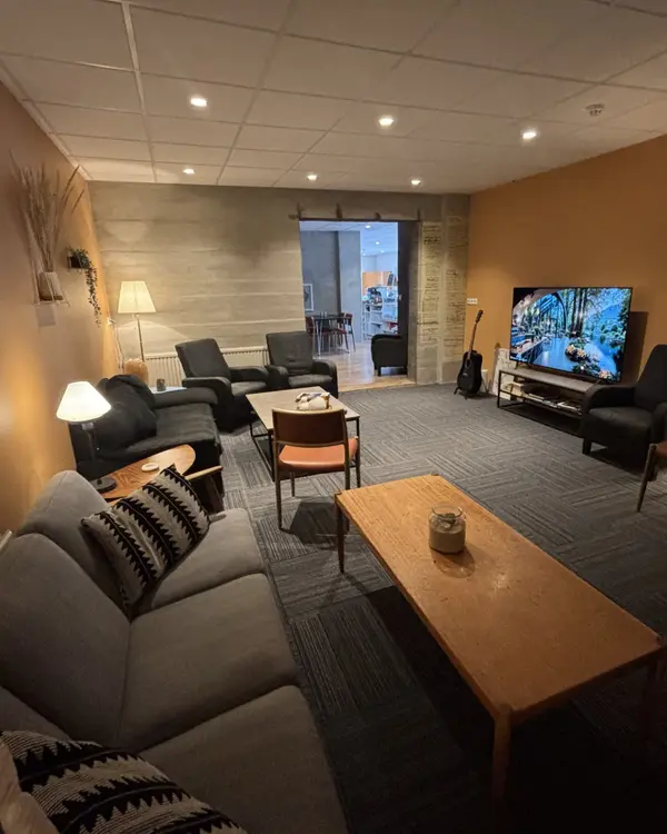 The guest lounge with sofas and a TV