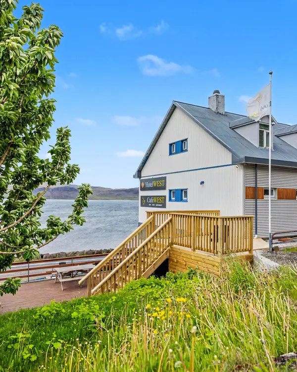 The Hotel West building above the fjord on a sunny day