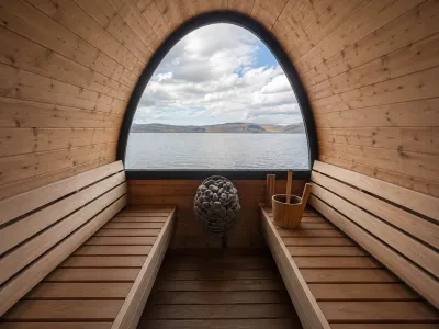 Guests enjoying the barrel sauna with a view over the fjord
